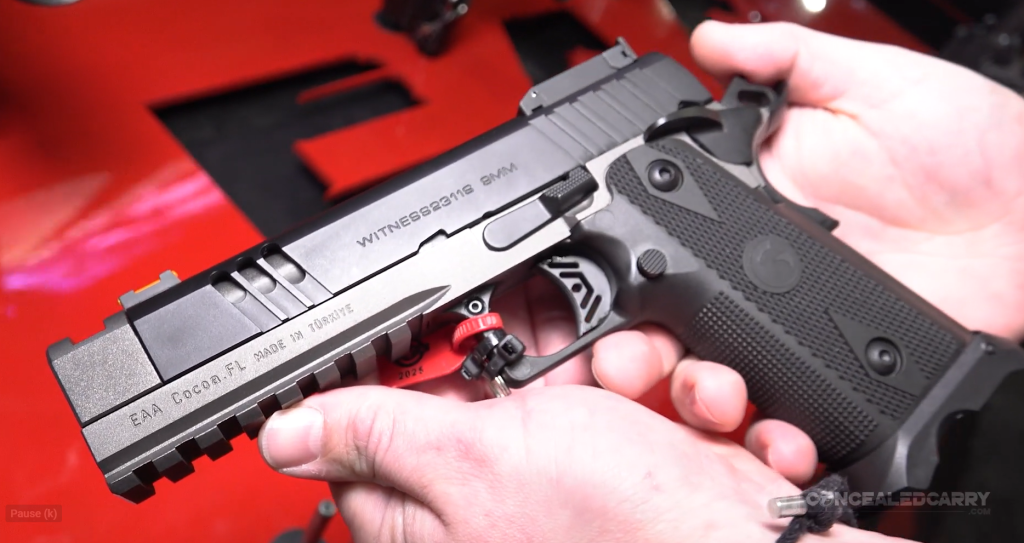 Close-up of the EAA Witness 2311 Match X 9mm pistol, featuring an RMSc optic-ready slide, skeletonized trigger, and a tactical accessory rail.