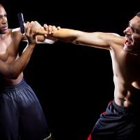 Martial artist disarming a criminal with a gun or close quarter combat