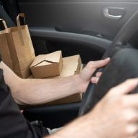 Food delivery driver in car