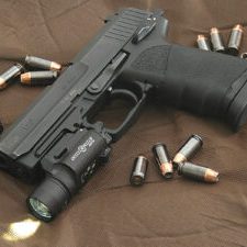 hk_usp_45_surrounded_by_-45_caliber_hornady_tap_p_jacketed_hollow_point_rounds