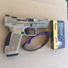 Pistol and gear occupying the A zone of an IPSC target.