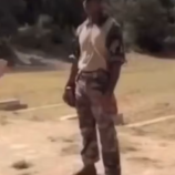 man shoots while another man is downrange