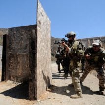 100817-N-4940H-003
AZUSA, Calif. (Aug. 17, 2010) Mass Communication Specialist 1st Class James E. Foehl, assigned to Fleet Combat Camera Group Pacific, provides cover while Max Joseph, director of the Tactical Firearms Training Team, tosses a flashbang grenade into a shoot house during Quick Shot 2010. Quick Shot is a Fleet Combat Camera Group Pacific semi-annual field training exercise. (U.S. Navy photo by Mass Communication Specialist Seaman Martin Carey/Released)